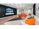 Bright living room featuring a large television, hardwood floors, and stylish furniture at 1293 Emerald Row, Clermont, FL 34714