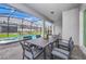 Outdoor patio featuring dining table, screened enclosure, and pool view at 1293 Emerald Row, Clermont, FL 34714