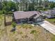 A fenced home with a long driveway and lush landscaping at 1296 Gage Ave, Deltona, FL 32738