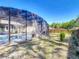 Expansive backyard with screened pool enclosure, offering a private outdoor space at 1296 Gage Ave, Deltona, FL 32738