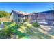 Backyard with green grass, green home, and a screened in pool at 1296 Gage Ave, Deltona, FL 32738