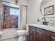 This bathroom has a shower/tub combo with tile surround, a toilet, and vanity with modern sink and fixtures at 1296 Gage Ave, Deltona, FL 32738