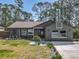 Charming single-story home featuring a landscaped front yard, mature trees and neutral colors at 1296 Gage Ave, Deltona, FL 32738
