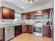 Kitchen features stainless steel appliances, attractive granite countertops, and wood flooring at 1296 Gage Ave, Deltona, FL 32738