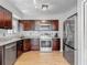 Well-lit kitchen features stainless steel appliances, attractive granite countertops, and wood flooring at 1296 Gage Ave, Deltona, FL 32738