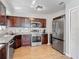 Well-lit kitchen features stainless steel appliances and attractive granite countertops and wood flooring at 1296 Gage Ave, Deltona, FL 32738