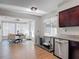 Bright eat-in kitchen adjacent to light filled Florida room and stainless steel appliances at 1296 Gage Ave, Deltona, FL 32738