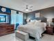 Large main bedroom features tile floors, ceiling fan, large windows and dark blue accent wall at 1296 Gage Ave, Deltona, FL 32738