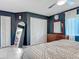 Spacious main bedroom with tile floors, ceiling fan, closet and stylish blue accent wall at 1296 Gage Ave, Deltona, FL 32738