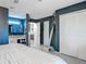 Bedroom provides access to the en-suite bath, large closets, and stylish blue accent wall at 1296 Gage Ave, Deltona, FL 32738