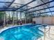 Sparkling enclosed pool with a screened enclosure and sunlit ambiance at 1296 Gage Ave, Deltona, FL 32738