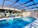 Inviting screened pool with outdoor seating, grill, and jacuzzi at 1296 Gage Ave, Deltona, FL 32738