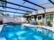 Inviting screened pool with tile accents and outdoor living space at 1296 Gage Ave, Deltona, FL 32738