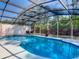 Enclosed pool with screened enclosure, offering a refreshing and private retreat at 1296 Gage Ave, Deltona, FL 32738