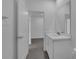 Bathroom featuring a sleek vanity with modern fixtures, mirror, and wood-look flooring at 1343 Wood Line Dr, Deland, FL 32720