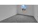 Empty bedroom with a window view and neutral carpet at 1343 Wood Line Dr, Deland, FL 32720