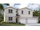 Charming two-story home with a two-car garage, landscaped yard, and neutral color scheme at 1343 Wood Line Dr, Deland, FL 32720