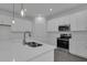 Bright kitchen featuring an island, white cabinets, countertops, and stainless-steel appliances at 1343 Wood Line Dr, Deland, FL 32720