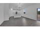 Open concept kitchen with white cabinets, island, and gray wood-look floors at 1343 Wood Line Dr, Deland, FL 32720