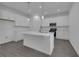 Modern kitchen featuring an island with white countertops and stainless-steel appliances at 1343 Wood Line Dr, Deland, FL 32720