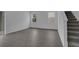 Bright living room with gray wood-look flooring and access to the upper floor via stairs at 1343 Wood Line Dr, Deland, FL 32720