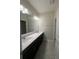 Bright bathroom features dual sinks, a large mirror, and modern vanity with sleek finishes at 14143 Title Way, Winter Garden, FL 34787