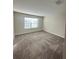 Bright bedroom with a large window offering plenty of natural light and neutral carpet at 14143 Title Way, Winter Garden, FL 34787