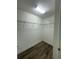 Walk-in closet with installed shelving and laminate floors for organized storage at 14143 Title Way, Winter Garden, FL 34787