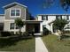 Charming townhouse with a well-manicured lawn and a welcoming entryway under a bright blue sky at 14143 Title Way, Winter Garden, FL 34787