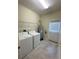 Functional laundry room with a washing machine, dryer, and tiled floor at 14143 Title Way, Winter Garden, FL 34787