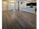 Spacious living room flows into the kitchen, boasting wood floors and plenty of natural light at 14143 Title Way, Winter Garden, FL 34787