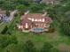Stunning aerial view of a luxury home with a pool, lush landscaping, and long driveway at 1526 Bluewater Run, Chuluota, FL 32766