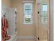 Bright bathroom with a robe hanging on the wall next to the large shower with glass door at 1526 Bluewater Run, Chuluota, FL 32766