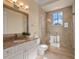 Well-lit bathroom featuring granite countertops, a vanity mirror, and a glass-enclosed shower at 1526 Bluewater Run, Chuluota, FL 32766