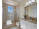 Clean bathroom featuring a glass-enclosed shower, granite countertops, and a bright, airy feel at 1526 Bluewater Run, Chuluota, FL 32766