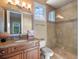 Stylish bathroom features a granite countertop, wood cabinets, and a glass-enclosed shower at 1526 Bluewater Run, Chuluota, FL 32766