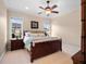 Comfortable bedroom features a ceiling fan, crown molding, and two windows allowing for natural light at 1526 Bluewater Run, Chuluota, FL 32766