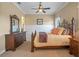 Inviting bedroom boasts a comfortable bed, dark wood furnishings, and wainscotting at 1526 Bluewater Run, Chuluota, FL 32766
