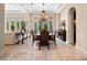 Bright dining room features elegant chandelier and view of the exterior through multiple large windows at 1526 Bluewater Run, Chuluota, FL 32766