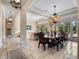 Dining room and hallway with chandelier, tile flooring, and French doors to the exterior at 1526 Bluewater Run, Chuluota, FL 32766