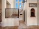 Grand foyer with soaring ceilings, decorative iron staircase, arched doorway, and travertine flooring at 1526 Bluewater Run, Chuluota, FL 32766