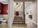Grand foyer featuring a curved staircase, iron railings, stone floors and lots of natural light at 1526 Bluewater Run, Chuluota, FL 32766