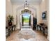 Spacious foyer with double entry doors, a patterned rug, tile flooring, and views of the front yard at 1526 Bluewater Run, Chuluota, FL 32766