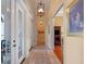 Long hallway featuring tile floors, decorative lighting, and access to multiple rooms at 1526 Bluewater Run, Chuluota, FL 32766