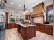 Gourmet kitchen with custom cabinetry, granite countertops, center island, tile floors, and stainless appliances at 1526 Bluewater Run, Chuluota, FL 32766