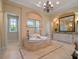 Luxurious bathroom featuring a soaking tub, walk-in shower, double vanity, and elegant lighting at 1526 Bluewater Run, Chuluota, FL 32766
