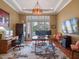 Home office with custom desk, hardwood floors, ample lighting, and backyard views at 1526 Bluewater Run, Chuluota, FL 32766