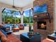 Outdoor covered patio with a stone fireplace and comfortable seating, perfect for entertaining at 1526 Bluewater Run, Chuluota, FL 32766