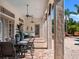 Spacious outdoor patio featuring brick flooring, columns, outdoor seating, ceiling fans, and access to the pool area at 1526 Bluewater Run, Chuluota, FL 32766
