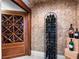 Charming wine cellar with custom built-in shelving and a decorative textured wall at 1526 Bluewater Run, Chuluota, FL 32766